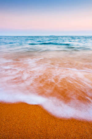 Close up of a wave washing up on the shore.の写真素材