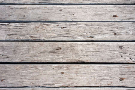 Looking down on an old, weathered, grey wooden deck.  Wood texture background.の写真素材