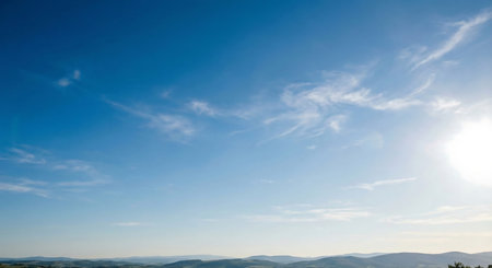 Blue sky with white clouds and sun. Beautiful nature background. Panoramic image.の素材