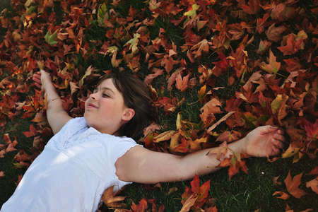 Girl in Leavesの写真素材