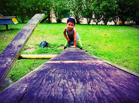 Boy playing in playgroundの素材