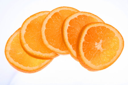 Five orange slices fanned out ontop of one another.