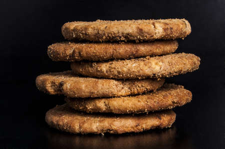 Fresh and tasty oat biscuits on black backgroundの写真素材