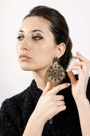 Portrait of beautiful woman with beautiful make-up and expensive earrings.の写真素材