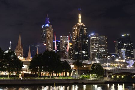 city of Melburne in the night with canal and skycraperの写真素材