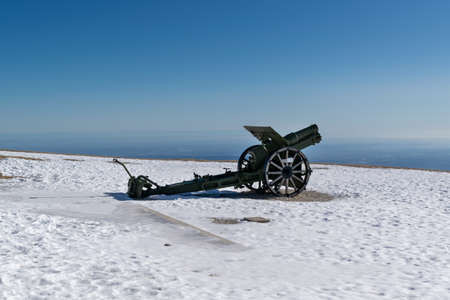 WWI cannon placed on the Military Shrine of Cima Grappa covered by snow. This is one of the main military ossuaries of the First World War. Monte Grappa, Veneto, Italyの写真素材