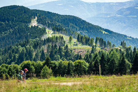 Mountain people of the Dolomites walk on the green peaks covered with fir woods. Cima Campo, ArsiÃ¨, Bellunoのeditorial素材