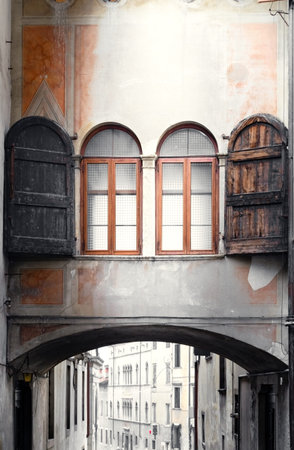 Corridor with windows connecting two ancient buildings in the historic center of the village of Feltre, Belluno, Italyの写真素材