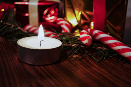 Candle and christmas decoration on wooden boardの写真素材