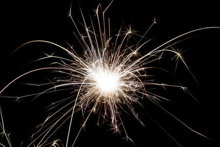 Christmas and New Year sparks burns on black backgroundの写真素材