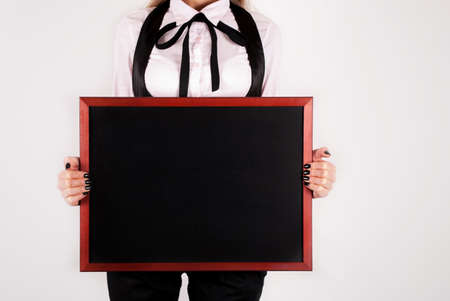 Black board in hand of elegant girl with tie. Close upの写真素材