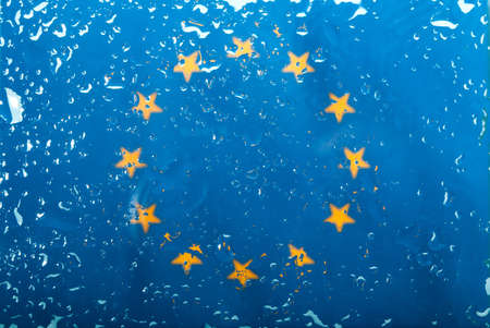 Drops of water on European Union flag background. Shallow depth of field. Selective focus. Tonedの写真素材
