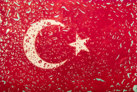 Drops of water on Turkish flag background. Shallow depth of field. Selective focus. Tonedの写真素材