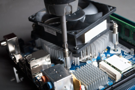 NIS, SERBIA - MARCH 10 2018: Cpu cooler installation on motherboard with screwdriver. Close up, selective focusのeditorial素材