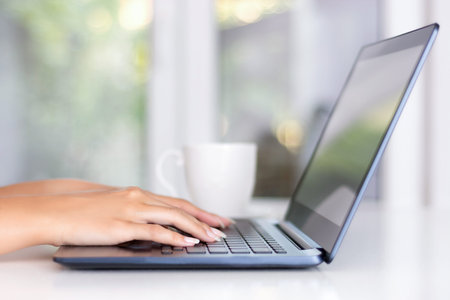 Beautiful woman programmer hands typing on laptop keyboard in office. Modern job and work concept....