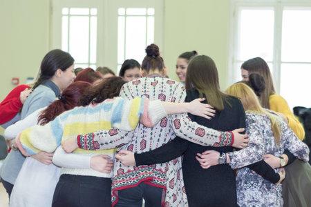 Nis, Serbia - February 13, 2019: Young girls having group hug in classroom. Circle of trust and...