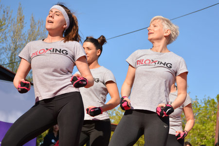Nis, Serbia - April 20, 2019 Group of happy woman practicing Piloxing sport in an outdoor class in...