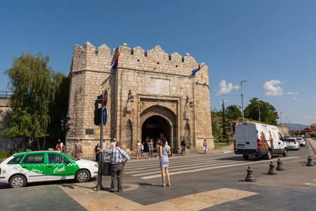 Nis, Serbia - August 28, 2019: Old medieval fortress and people are waiting for the traffic light to cross the street across the zebra on summer sunny day in the city of Nis, Serbiaのeditorial素材