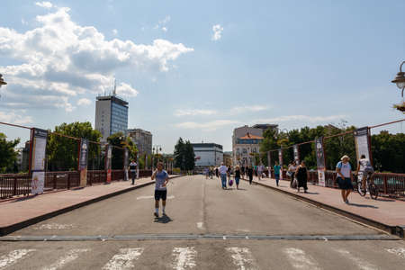 Nis, Serbia - August 28, 2019: People walking on the street bridge and modern buildings in the distance on summer sunny day in the city of Nis, Serbiaのeditorial素材