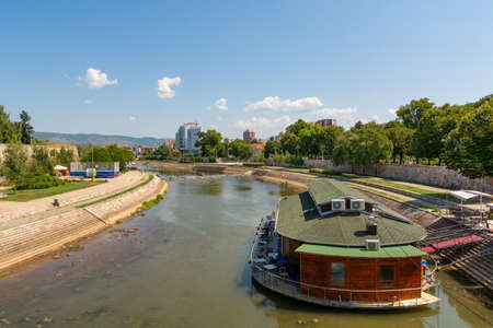 Nis, Serbia - August 28, 2019: Raft restaurant on river Nisava and a quay promenade park on summer sunny day in the city of Nis, Serbiaのeditorial素材