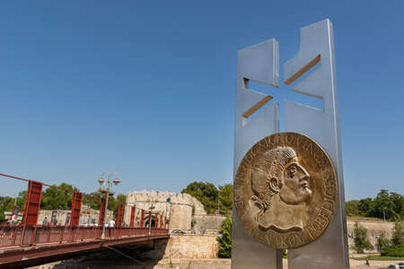 Nis, Serbia - August 28, 2019: Monument to Constantine the Great with christogram and old fortress and bridge in the background on summer sunny day in the city of Nis, Serbiaのeditorial素材