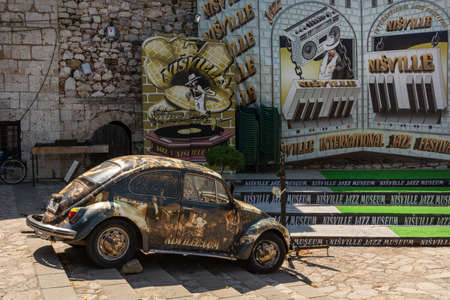 Nis, Serbia - August 28, 2019: Volkswagen beetle old timer car with pictures on the jazz theme in open jazz museum on summer sunny day in the city of Nis, Serbiaのeditorial素材
