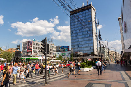 Nis, Serbia - August 28, 2019: Many people walking on a pedestrian crossing in downtown and modern...