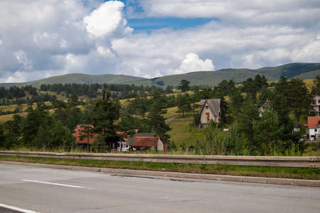 Zlatibor, Serbia - July 25. 2020 View of the mountain from the road and ethno village with wooden houses on the clearing in a natural resort on Zlatibor, Serbiaのeditorial素材