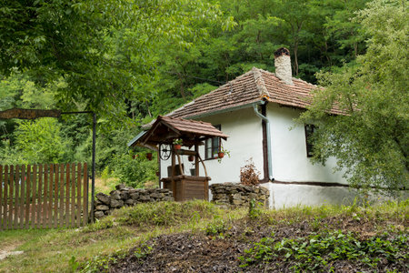 Malo Bonjince, Serbia - July 10. 2022 Ethnic style house with an old well in the forest on a summer day in Serbia, Europeのeditorial素材
