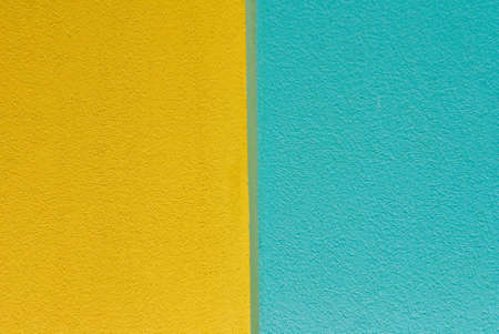 Wall of blue and yellow textured paintの写真素材