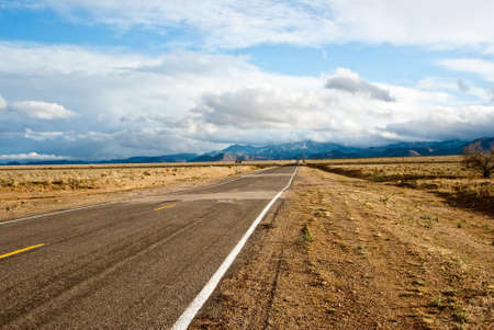 Road through desert in winter stormの写真素材