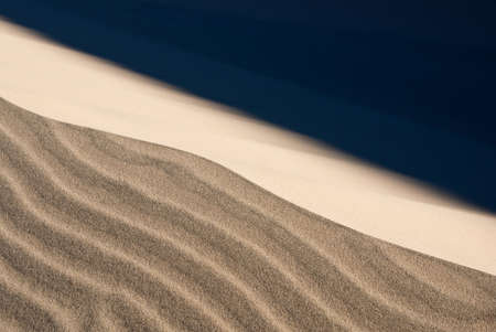 Stormy winds blow the fine sand on desert dunesの写真素材