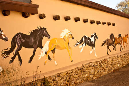 TAOS, NEW MEXICO USA  OCTOBER 20  Mural depicting wild painted horses on walls of old town shown on October 20, 2011 in Taos, New Mexico  Taos is world famous for arts and culture のeditorial素材