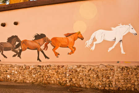 TAOS, NEW MEXICO USA  OCTOBER 20  Mural depicting wild painted horses on walls of old town shown on October 20, 2011 in Taos, New Mexico  Taos is world famous for arts and culture のeditorial素材