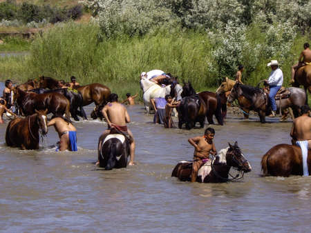 Indian warriors cool off in rivee after the reenactment of the battleのeditorial素材