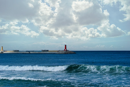 Lighthouse on the background of the sea and blue sky with clouds overlooking the East Sea in South Koreaの写真素材