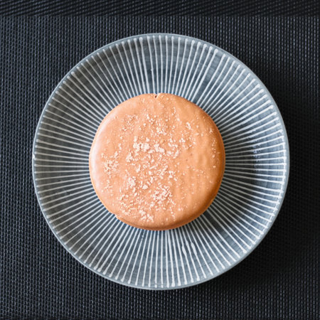 Macaron on a plate on a dark background, top viewの写真素材