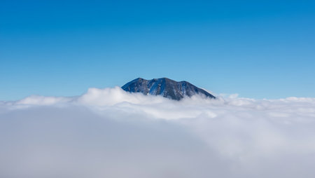 Mountain peak in the clouds. Panoramic view from above.の素材