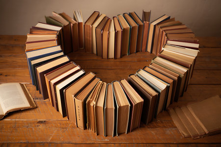 Heart made of books on wooden table. Education concept. Back to school.の素材