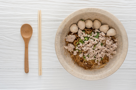 Bowl of noodles with vegetables on wooden table. delicious noodle. Instant noodle.の写真素材