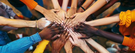 People of different races and skin colors joining their hands together.の素材