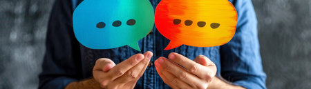 Close-up of male hands holding colorful speech bubbles. Communication conceptの素材