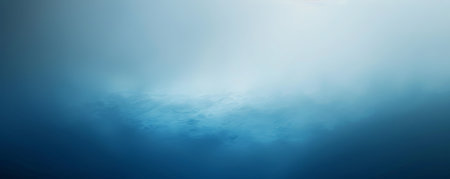 Abstract blue and white gradient background with soft, blurred textures.の素材