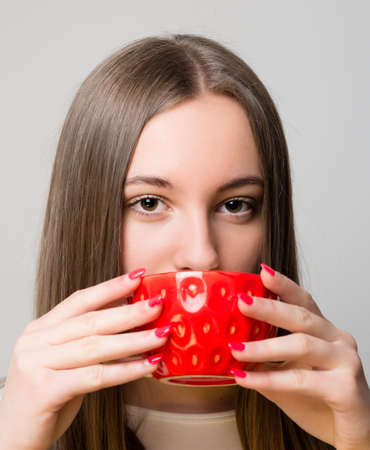 Young woman drinking a fruit teaの写真素材