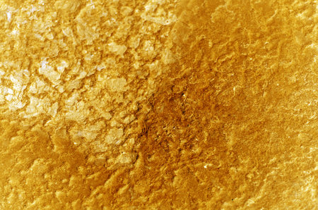 Abstract grunge cracked metal background golden texture with highlightの写真素材