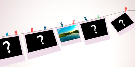 Question marks on photo frames hanging on a clothesline against a white backgroundの写真素材