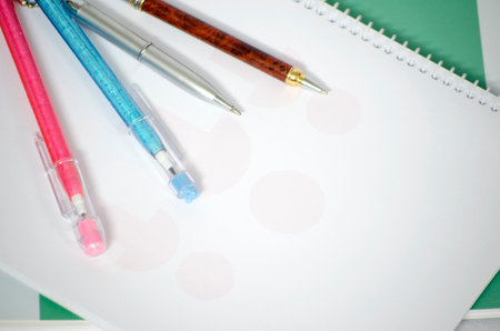 Pencils and notepad on a white background with copy spaceの写真素材