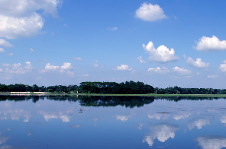 Landscape view of the lake with blue sky and white clouds.の写真素材
