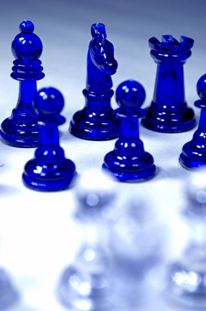 blue chess pieces on a white background, shallow depth of field.の写真素材