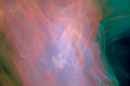 abstract multicolored smoke on a black background close-upの写真素材